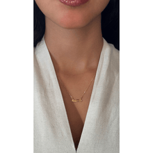 Load image into Gallery viewer, Double Arabic letter necklace in 18-karat yellow gold with a yellow gold chain on a girl.