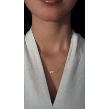 Load image into Gallery viewer, 18-karat yellow gold Double Arabic letter necklace with a 18-karat gold chain on a girl.