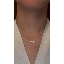 Load image into Gallery viewer, 18-karat white gold Double Arabic letter necklace with a natural diamond on a girl.
