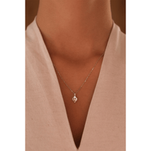Load image into Gallery viewer, 18-karat white gold necklace with a pendant in a traditional Sadu design and natural diamond in the centre.
