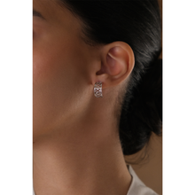 Load image into Gallery viewer, 18k white gold hoop earrings on a girl with traditional arabic motif.

