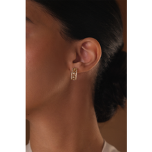Load image into Gallery viewer, 18k yellow gold hoop earrings with pave diamonds on a girl with traditional arabic motif.
